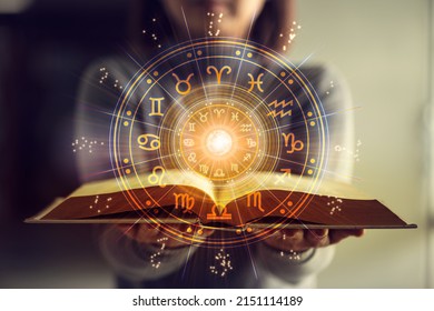 Woman holding a astrology book. Astrological wheel projection, choose a zodiac sign. Astrology esoteric concept. - Shutterstock ID 2151114189