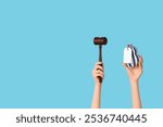 Woman holding auction gavel and antique vase on blue background