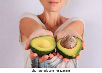 Woman Holding Avocado Closeup. Healthy Eating And Skin Care Concept