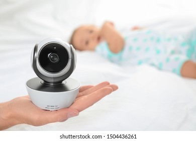 Woman Holding Baby Camera Near Child On Bed. Video Nanny