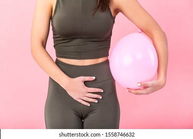 Woman Holding A Balloon, Feeling Bloated Concept, Woman Having Abdominal Pain Isolated On White