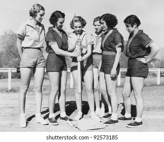 Woman Holding A Baseball Bat And Giving Training To Other Women