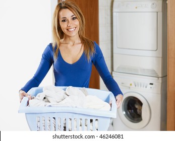 Woman Holding Basket Of Laundry And Looking At Camera