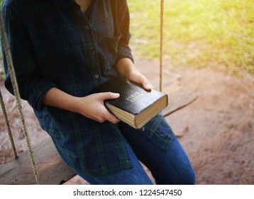 Woman Holding A Bible Book.