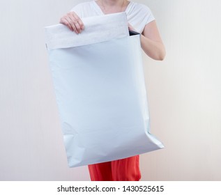 Woman Holding Big Poly Plastic Mailer Mailing Envelope