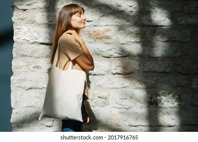 Woman Holding Black Canvas Tote Bag. Bag Mockup For Design.