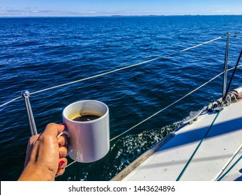 Woman Holding Black Coffee In White Cup On Sailing Boat Over Sea Water Holiday Summer Background