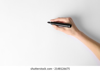 Woman holding black marker on white background, top view. Space for text