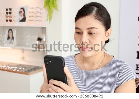 Woman holding black smartphone, woman using smartphone