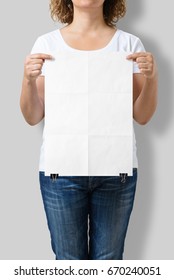 Woman Holding A Blank A3 Poster Mockup Isolated On A Gray Background. 