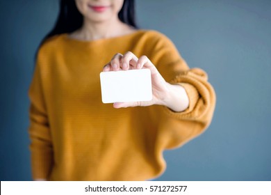 Woman holding blank business card for mock up