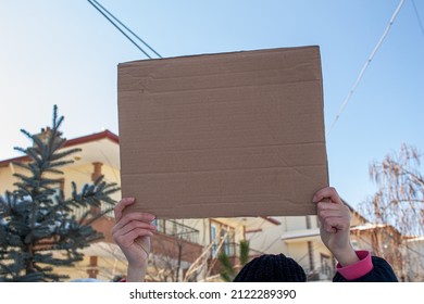 Woman Holding Blank Cardboard Box, Protesting Something. Copy Space For Text On Cardboard Box.