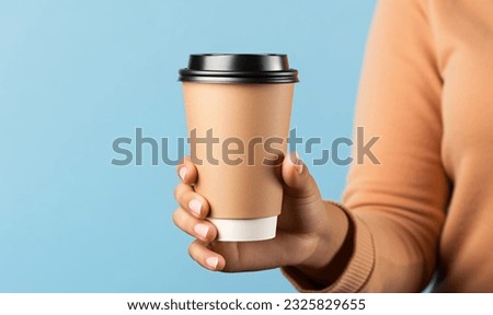 Woman holding a blank paper coffee cup, mockup