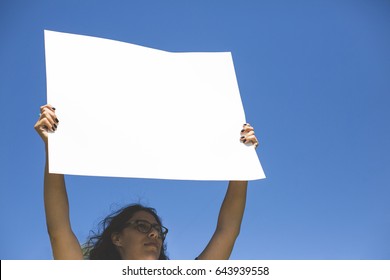 Woman holding blank protest sign