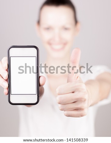 Woman holding blank smart phone and doing ok gesture