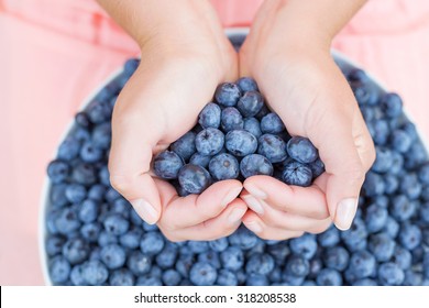 Woman Holding Blueberries In Hands
