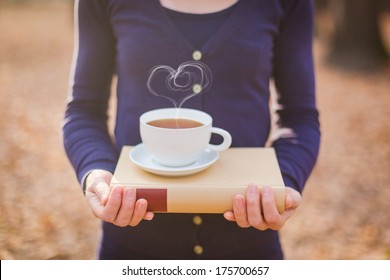 Woman Holding Book, Hot Tea Cup With Heart Shape