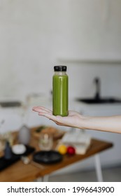 Woman Holding A Bottle Of Celery Juice