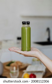 Woman Holding A Bottle Of Celery Juice