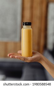 Woman Holding A Bottle Of Orange Juice