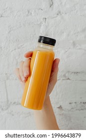 Woman Holding A Bottle Of Orange Juice