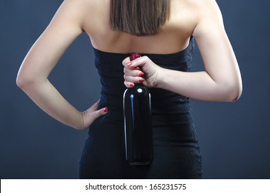 Woman holding bottle of wine