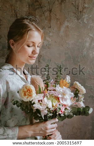 Similar – Woman makes festive bouquet with vase