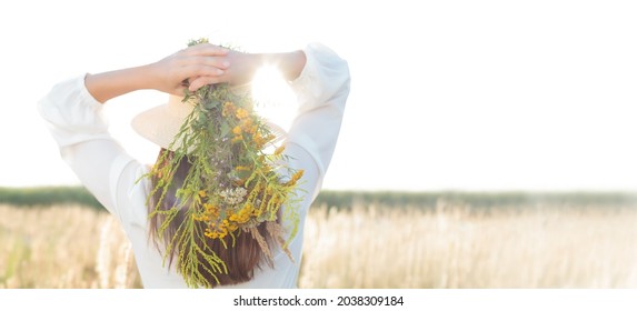 A woman holding a bouquet of herb, a natural medicine. Hair care - banner. Natural medicinal product . Text space.