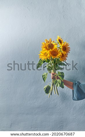 Woman holding bouquet of Sunflowers. Copy space