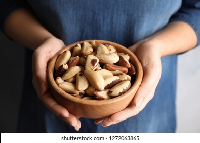 Woman Holding Bowl With Brazil Nuts, Closeup