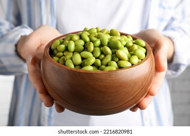 Woman Holding Bowl Of Edamame Beans, Closeup