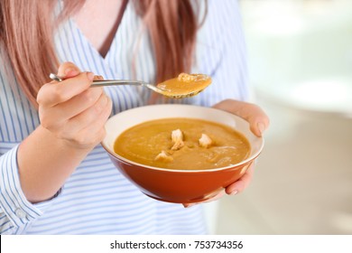 Woman Holding Bowl And Spoon With Homemade Lentils Creme Soup