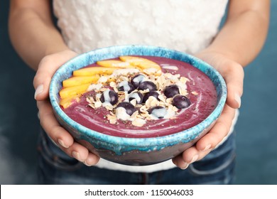 Woman Holding Bowl With Tasty Acai Smoothie, Closeup