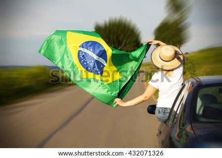 Woman holding Brazil flag - Sport fans traveling to Rio de Janeiro