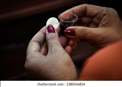 Woman Holding Bread And Wine In A Holy Communion.