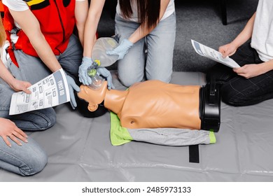 Woman holding breathing bag Ambu bag.Demonstrating CPR Cardiopulmonary resuscitation training medical procedure on CPR doll in the class.Paramedic demonstrate first aid practice for save life. - Powered by Shutterstock