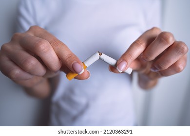 Woman Holding Broken Cigarette In Hands. Stop Smoking, Quit Smoking Or Refusing Cigarettes. Quit Bad Habit.