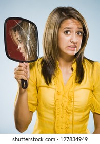 Woman Holding Broken Hand Held Mirror