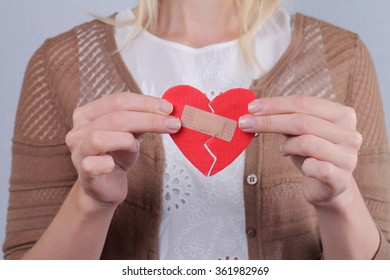 Woman Holding  Broken Heart Fixed By Plaster Close Up. Feelings And Emotions. Love Problems, Second Chance,hope, Feelings And Emotions Concept