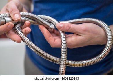 Woman Is Holding A Broken Shower Sprinkler Head In Her Hands And Changes To A New One