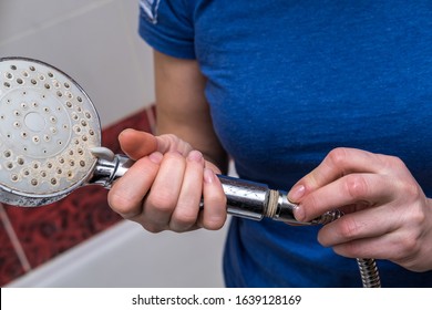 Woman Is Holding A Broken Shower Sprinkler Head In Her Hands And Changes To A New One