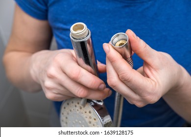 Woman Is Holding A Broken Shower Sprinkler Head In Her Hands And Changes To A New One