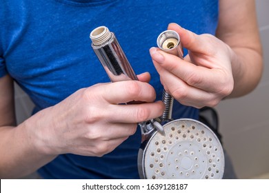 Woman Is Holding A Broken Shower Sprinkler Head In Her Hands And Changes To A New One