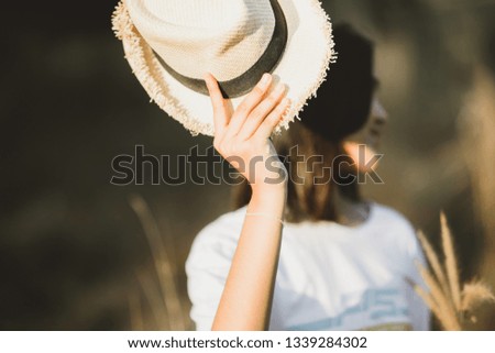 
Woman holding a brown hat.selective focus.