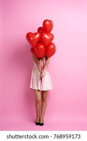 Woman Holding Bunch Of Heart Shape Balloons