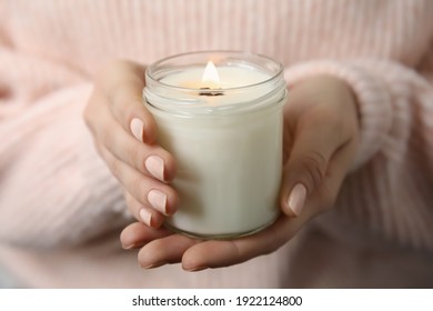 Woman Holding Burning Candle With Wooden Wick, Closeup