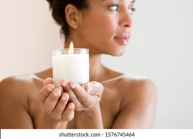 A Woman Holding A Candle