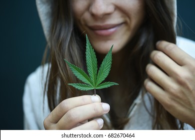 Woman Holding A Cannabis Leaf 