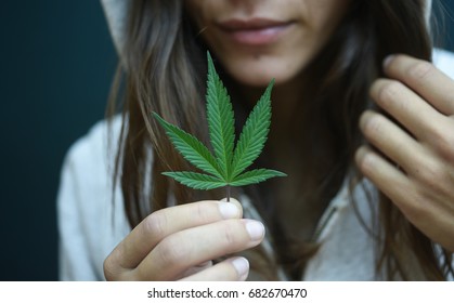 Woman Holding A Cannabis Leaf 