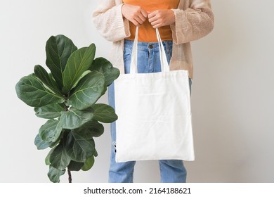 Woman Holding Canvas Tote Bag On White Background. Reusable Eco Bag For Shopping. Eco Friendly Concept. Mockup For Design.